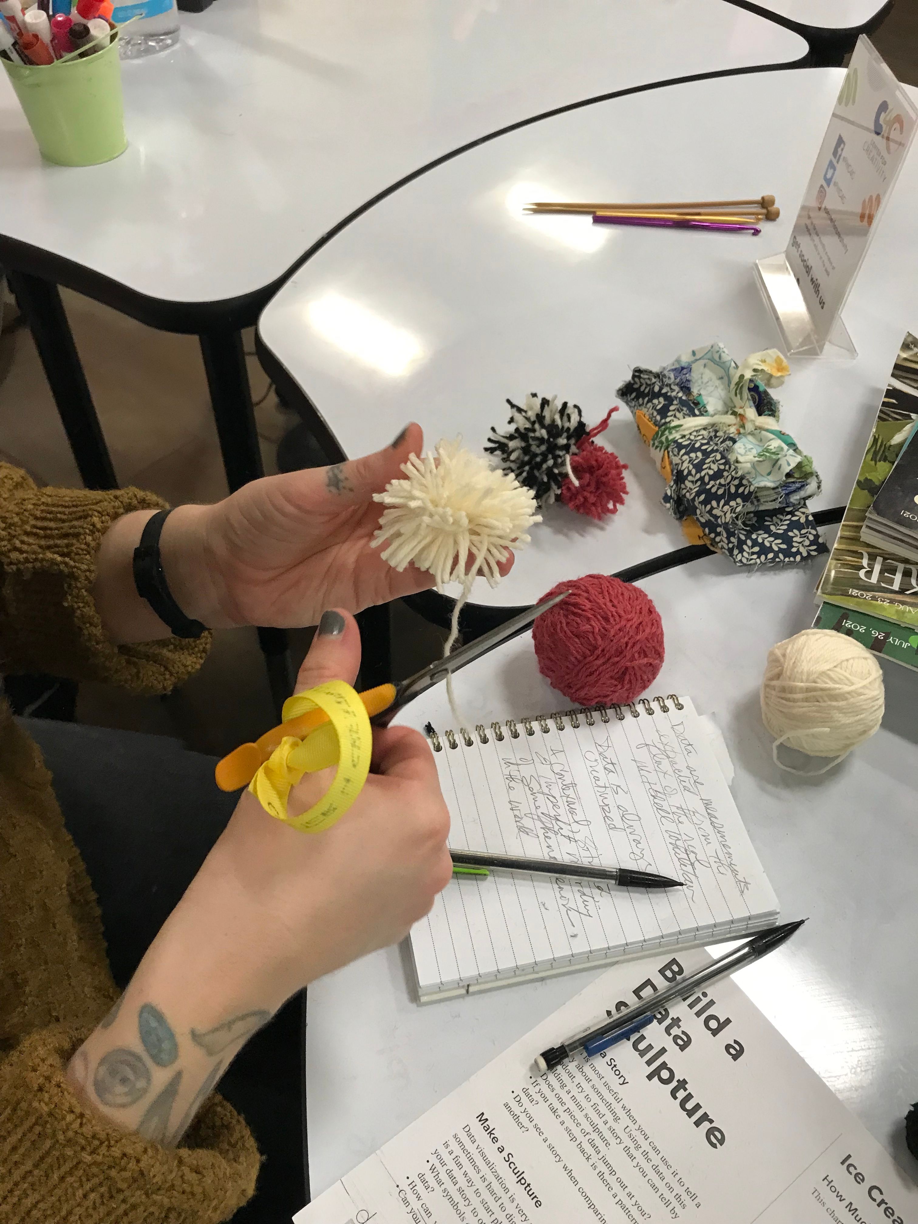 hands cutting yarn 